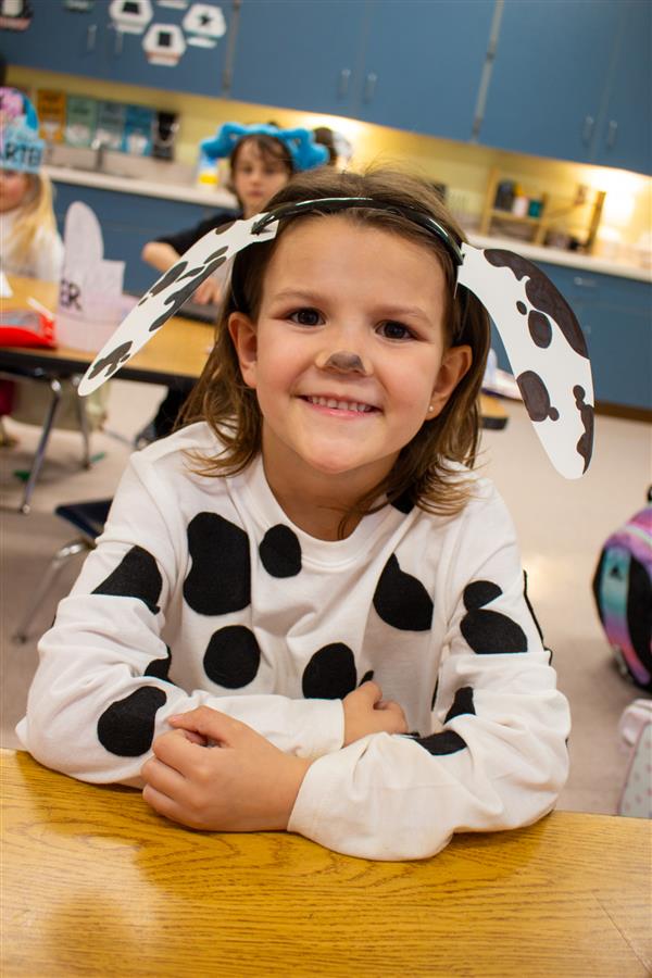 girl smiling dressed as dalmatian dog